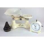 A set of cream enamel metal kitchen scales with weights, 26cm, and a Smiths stop clock