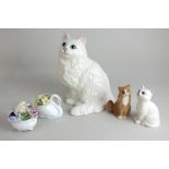 A large Royal Doulton white porcelain Persian cat with green eyes, 20.5cm, together with two small