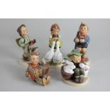 A collection of five Goebel Hummel porcelain figures of children in various pursuits