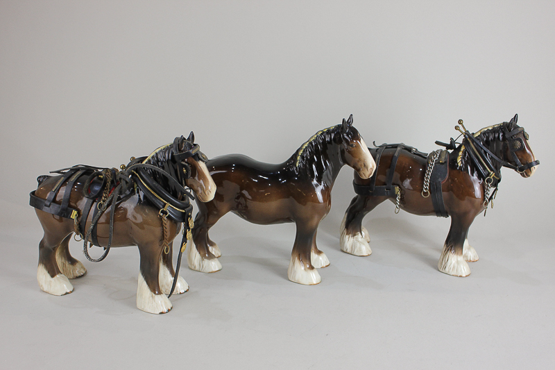 A Beswick model of a shire horse, brown with yellow ribbon, gloss, 21.6cm, together with two Beswick