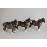 A Beswick model of a shire horse, brown with yellow ribbon, gloss, 21.6cm, together with two Beswick