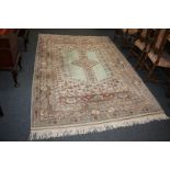 A Turkish wool carpet, cream ground with central stylized design with multiguard border, 184cm by