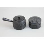 Two carved Irish box oak items comprising miniature saucepan and cover, and a lidded pot, both