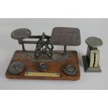 A set of postal scales with weights, the prices engraved on the plate, together with a spring letter