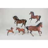 Four Beswick models of horses, comprising a cantering horse, brown, matt, 21.5cm, and three foals in