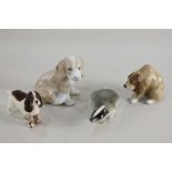 A Beswick model of a spaniel, a Szeiler model of a hound, a John Buck model of a dog, and a