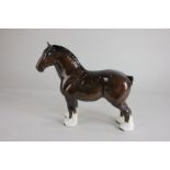 A Beswick model of a shire horse with yellow and red ribbon, brown, gloss, label to base, 26.5cm
