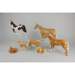 Seven Beswick models of horses, comprising two palomino horses, gloss and matt, both 20cm, and