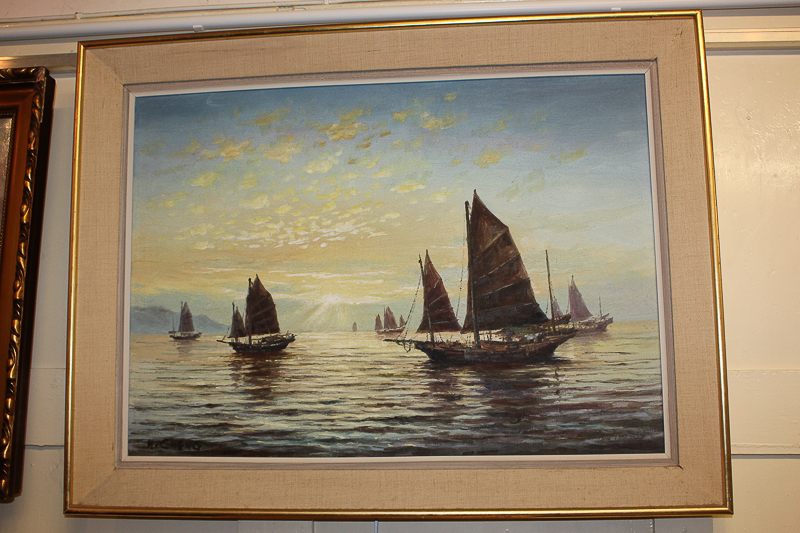 H Cheng, junk ships at sunset beneath a cloud studded sky, oil on canvas, signed, 49cm by 70cm