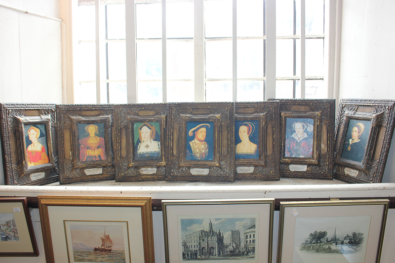 Seven colour prints depicting Henry VIII and his six wives, each ornately framed, 34cm by 29.5cm