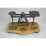 A set of postal scales on wooden base, with weights, 19cm