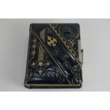 A Victorian photograph album of black and gilt design, containing thirty-two portrait and full