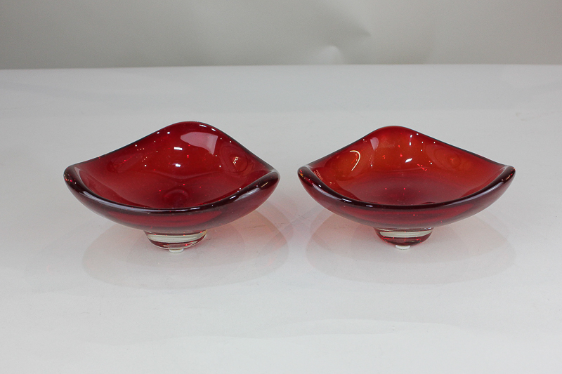 A pair of Whitefriars ruby red glass bowls of trigonal form, designed by Geoffrey Baxter (pattern