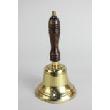 A brass school bell with wooden handle, 23cm high