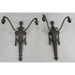 A pair of two-branch metal wall lights decorated with finial and drapes (a/f - must be tested by