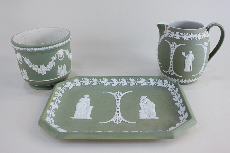 A Wedgwood Jasperware tray, jug and jardiniere, all with green ground and depicting classical