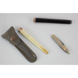 A 9ct gold cased penknife engraved MBR, 5.5cm, and two gold mounted cheroot holders, one in