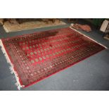A large Bokhara rug, crimson ground with four rows of elephant foot motifs within multiguard border,