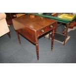 A 19th century mahogany Pembroke table with end drawer and dummy drawer, on turned legs and castors,
