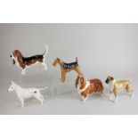 Five Beswick models of dogs comprising an Airedale terrier 'Cast Iron Monarch', black and tan,