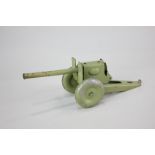 A green tin plate toy cannon with firing mechanism, 22.5cm long, play worn