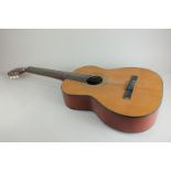 A Paramount Grand Concert acoustic guitar with inlaid design on blond wood, with case, 100cm