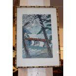 A Japanese woodcut print depicting figures on a bridge, mountains beyond, with character marks, 35.