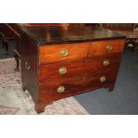 A campaign style mahogany chest of two short over two long drawers, with cross banded top, on