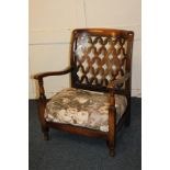 An early 20th century low armchair with lattice panel back