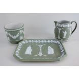 A Wedgwood Jasperware tray, jug and jardiniere, all with green ground and depicting classical