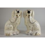 A pair of Beswick models of Old English dogs in white and gold, from the Mantelpiece Dogs series,