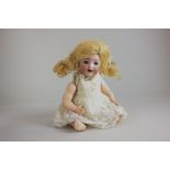 A Kammer & Reinhardt bisque head baby doll marked K star R No 22, with sleeping brown eyes, open