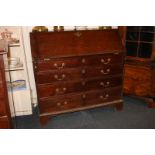 A George III mahogany bureau with fall front enclosing fitted interior of small drawers and pigeon