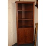 A stained pine corner cabinet with two adjustable shelves above cupboard, 81cm