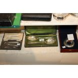 A cased pair of Mappin & Webb silver plate berry tablespoons in fitted case with green silk and