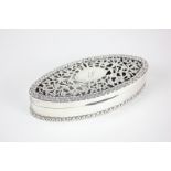 An Asprey silver dressing table box, oval form with pierced floral decorated lid, engraved