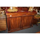 A mahogany sideboard with beaded decoration and raised scroll back, above two drawers and two