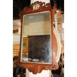 A Chippendale style fret cut wall mirror with gilt decoration and bird surmount, mirror plate 54.5cm