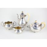 A Victorian silver matched four piece tea and coffee set, circular baluster form with scroll