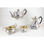 An Edward VII silver four piece matched tea and coffee set, oval form with demi fluting and cast