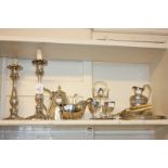 A pair of Rococo style silver plated candlesticks, 26cm high, a four egg cup stand with spoons,