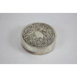 A Chinese silver circular box, the lid decorated with bamboo, impressed marks to base, 2.5oz, 7.5cm