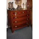 A Victorian banded mahogany serpentine chest of three short over three long drawers, stamped T