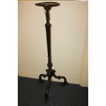 A mahogany jardiniere stand on carved fluted baluster stem and scroll carved tripod feet, 121cm