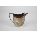 A George V silver cream jug, oval shape with demi reeding, maker Richard Burbridge, Sheffield