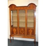 An Edwardian inlaid mahogany display cabinet with double dome top, central glazed panel flanked by