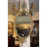 An Adam style giltwood and gesso oval girondelle wall mirror with shield and foliate pierced