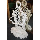 A Coalbrookdale style white painted cast iron umbrella and stick stand, the bow and floral scroll