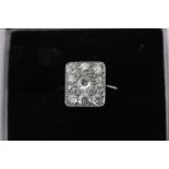 A diamond plaque ring, the rectangular table pave set with eleven graduated old cuts