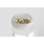 A diamond three stone ring, claw set with graduated old cuts in 18ct yellow gold